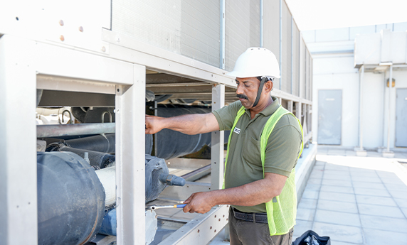 a man wearing a helmet and green vest looking havc system