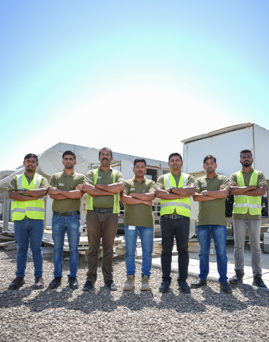 a group of men standing together with their arms crossed